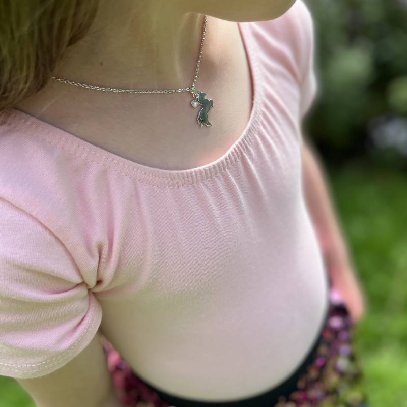 Little girl wearing Sterling Silver Horse Pendant with Sapphire Charm on an Extendable Chain Necklace