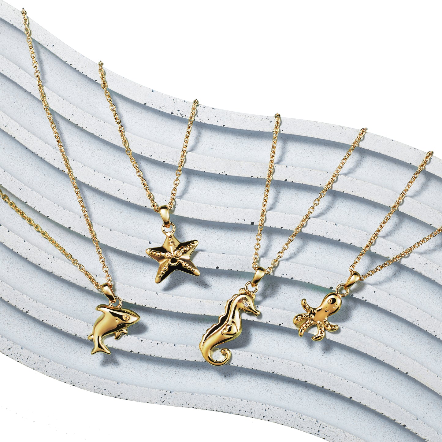 Under the Sea collection of gold children's necklaces including shark, starfish, seahorse and octopus, all on Extendable Chain Necklaces