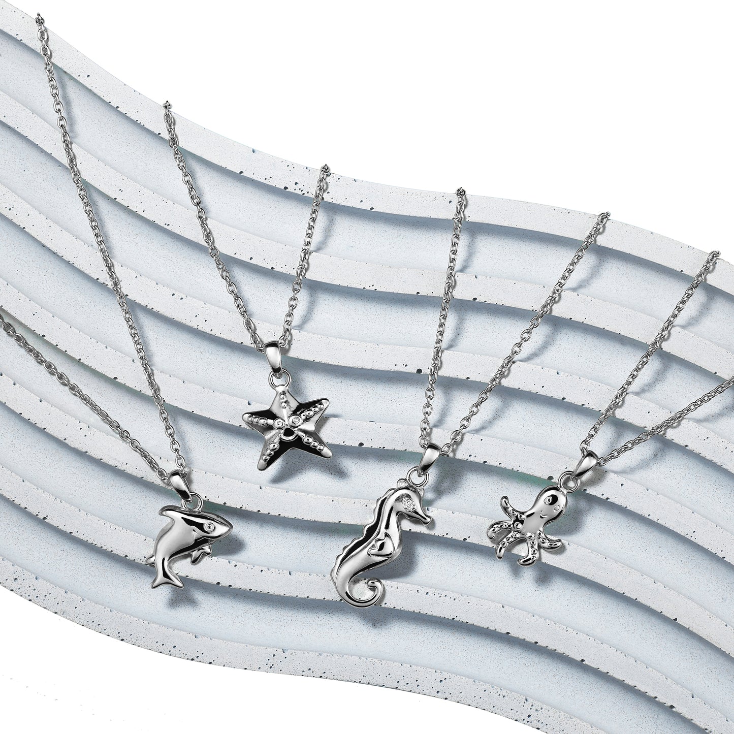 Under the Sea collection of silver children's necklaces including shark, starfish, seahorse, and octopus all on Extendable Chain Necklaces